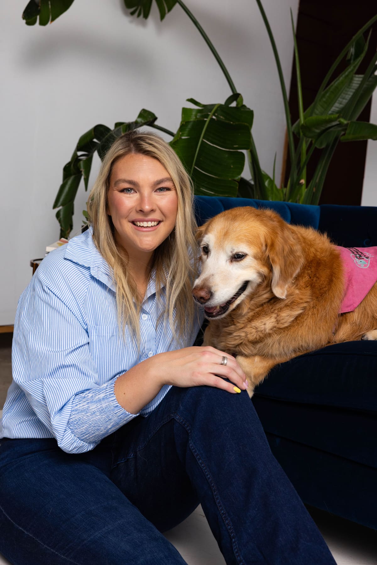 Hannah Snider seated with Lola in the Lola & Me Therapy office.
